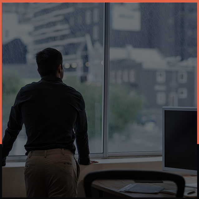 Man looking out office window